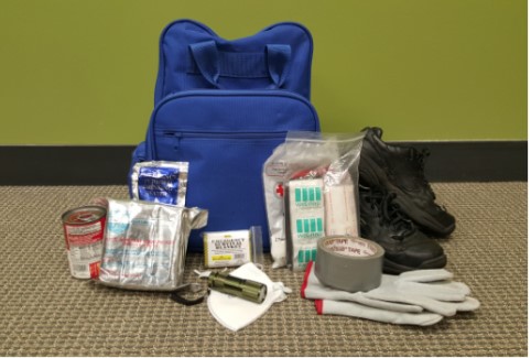 Emergency kit with blue backpack and various emergency supplies