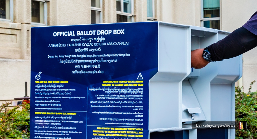 Person putting voting ballot in official drop-box