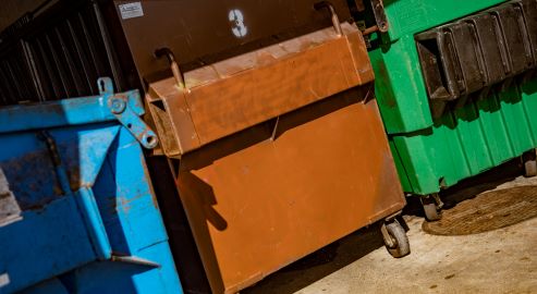 Blue, brown, and green dumpsters