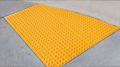 Yellow curb-cut for wheelchair users