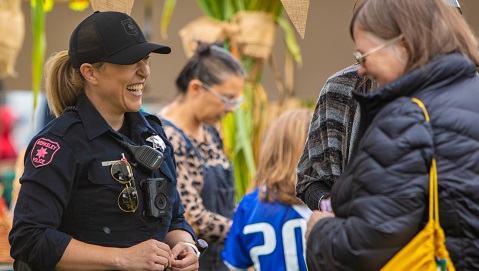 Smiling Police Officer talking to the public