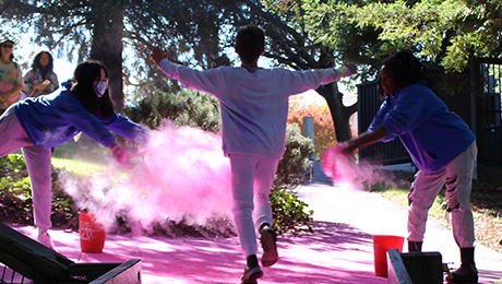 Youth running through colored powder
