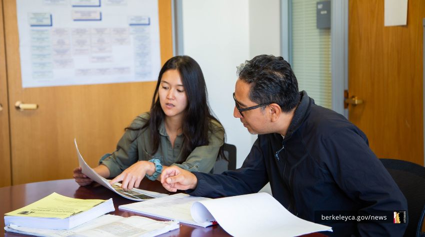 Two coworkers reviewing plan documents together