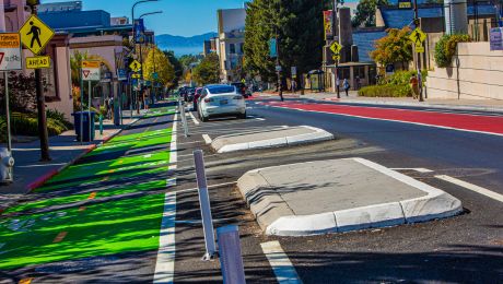 Street with separated bicycle track, pedestrian islands, and a bus-only lane