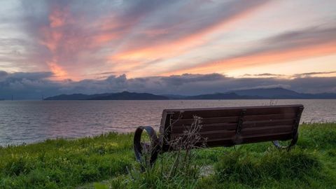 Bench on Bay trail overlooking the water at sunset.  