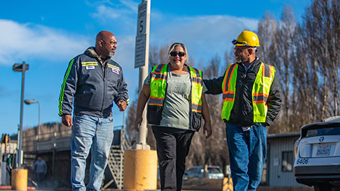 Three employees in Public Works uniforms 