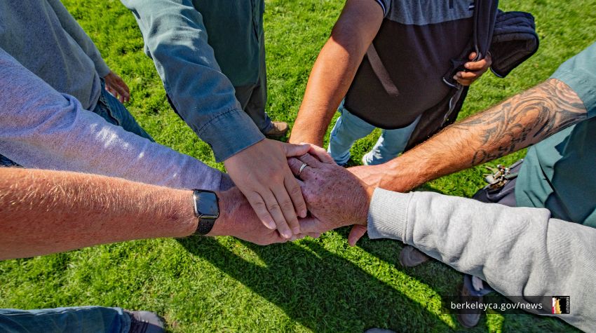 Team of people stacking hands