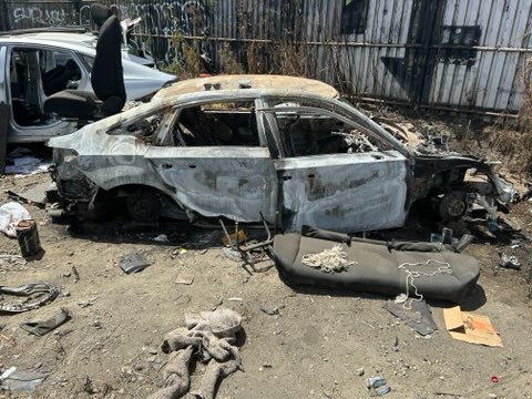Photo of stripped and burned vehicle