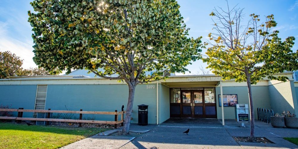 Single-story older building in a park