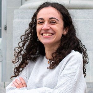 Headshot of a young woman with curly brown hair