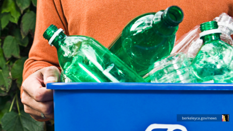 Person carries out recycling in blue bin
