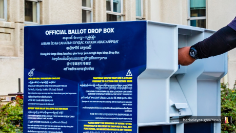 Person putting voting ballot in official drop-box