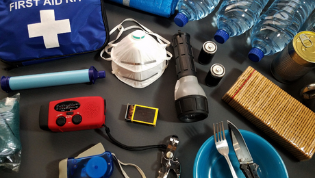 Photo of First aid kit, mask, flashlight, canned food, water in bottles