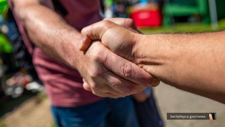 Two people shake hands