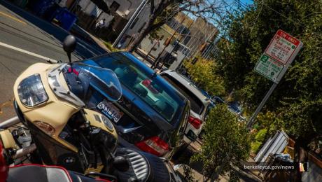 Parked cars and a motorcycle parked in a Residential Parking Permit zone