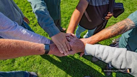 Team of people stacking hands