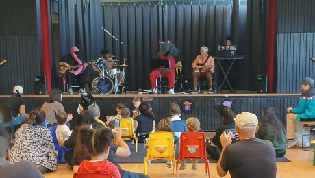 The Story-Time Band performing onstage at Frances Albrier Community Center.