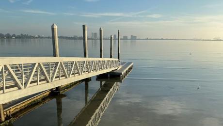Ramp descends out to a floating dock on the bay