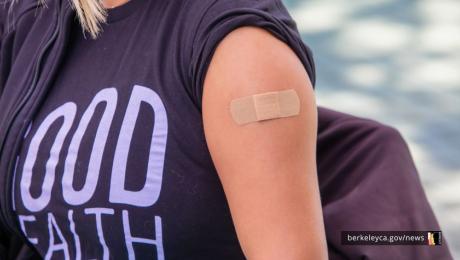 Person with adhesive bandage on their upper arm