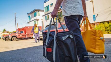 Person carrying large bags in a parking lot