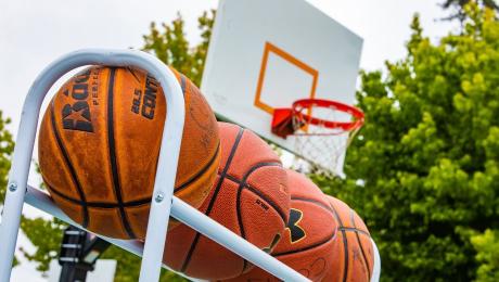 Basketballs with a hoop in the background