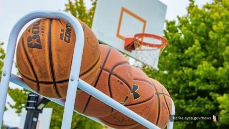 Basketballs sit in a rack outside