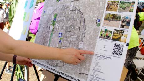 A person points to an element of the project's engagement map.