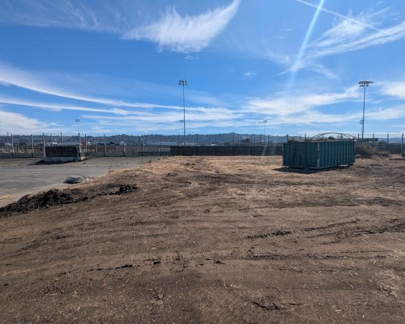 Tom Bates Sports field pre-construction dirt field and sports field in the background