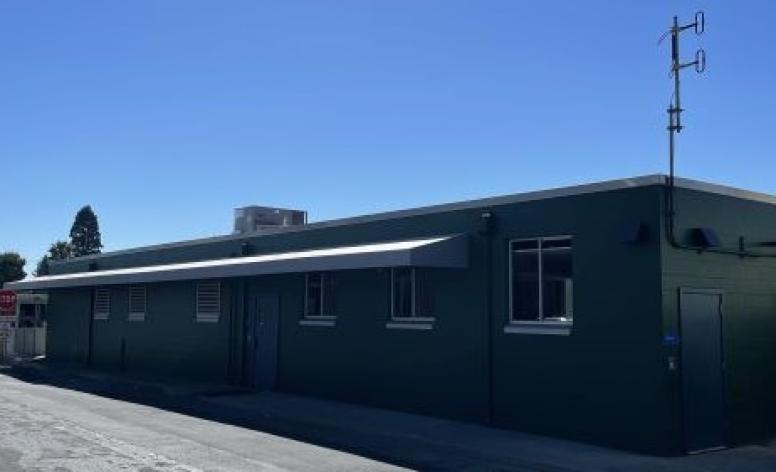 Exterior of newly renovated Corporation Yard Green Room with new green paint